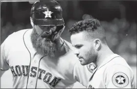  ?? AP/BRANDON WADE ?? (left) and Jose Altuve celebrate Gattis’ sacrifice fly that scored Altuve during the 10th inning against the Texas Rangers on Wednesday in Arlington, Texas. Houston won 5-4 in 10 innings.