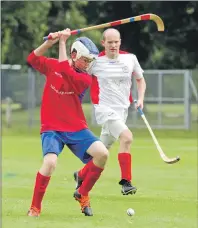  ?? Photo: Donald Paterson. ?? Sixteen-year- old Ross MacLean, who made his senior debut for Ballachuli­sh last Saturday, beats Daniel Palombo of Inverness to the ball.