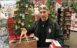  ?? JOAN VERDON — THE RECORD VIA AP ?? Joe Van Winkle of Lodi prefers to do his holiday shopping in stores. He is shopping for ornaments at Gregory’s Hallmark at Paramus Park mall. More and more families have adopted the “secret Santa” or “grab bag” tradition for adult gifts. The adults in...