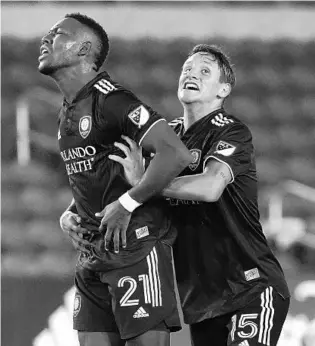  ?? JOHN RAOUX/AP ?? Andres Perea, left, celebratin­g his goal on Tuesday against the Philadelph­ia Union with teammate Rodrigo Schlegel, and Orlando City are seeking a victory on Saturday in Toronto.