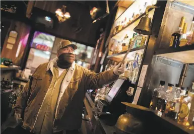  ?? Photos by Santiago Mejia / The Chronicle ?? Frank Martinez rings the lastcall bell to alert outdoor diners at the Old Wagon Saloon & Grill in San Jose.