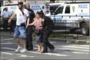  ?? THE ASSOCIATED PRESS ?? Police help people cross the street outside the Bronx Lebanon Hospital in New York after a gunman opened fire there on Friday, June 30, 2017.