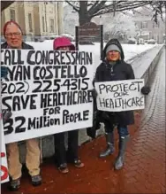  ?? BILL RETTEW – DIGITAL FIRST MEDIA ?? Citizens hold signs as they rally for health care outside the West Chester office of U.S. Rep. Ryan Costello on Friday.