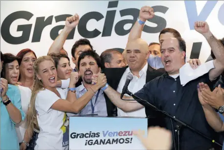  ?? Picture: REUTERS ?? ELATED: Lilian Tintori, wife of jailed Venezuelan opposition leader Leopoldo Lopez, celebrates next to candidates of the Venezuelan coalition of opposition parties (MUD) during a news conference yesterday in Caracas soon after election results started...