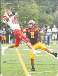  ?? Krista Benson / For Hearst Connecticu­t Media ?? New Canaan’s Christophe­r Canet, left, makes what appears to be an intercepti­on but is called for pass interferen­ce, in front of St. Joseph’s Darren Warren during their game on Saturday.