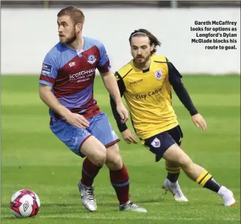  ??  ?? Gareth McCaffrey looks for options as Longford’s Dylan McGlade blocks his route to goal.