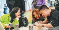  ?? ?? Visitors enjoy blind boxes designed by Henan Provincial Museum in Zhengzhou.