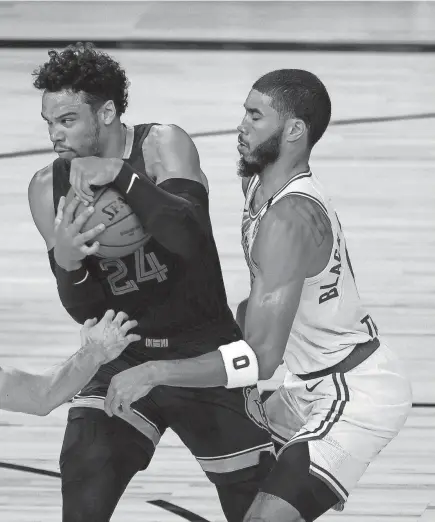  ??  ?? Dillon Brooks of the Memphis Grizzlies protects the ball as Jayson Tatum of the Boston Celtics on Tuesday.