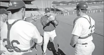  ?? John Hayes Associated Press ?? WITH THE DODGERS, Scioscia worked two years as minor league catching coordinato­r, here with prospects during winter workouts in 1997. He advanced to triple-A manager before stepping down.