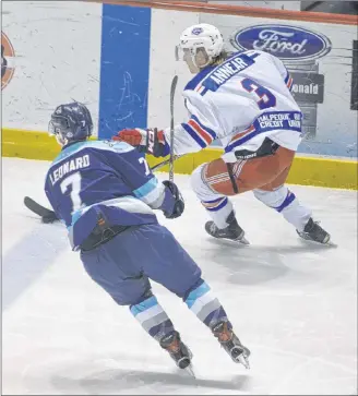  ?? JASON SIMMONDS/JOURNAL PIONEER ?? Summerside Western Capitals defenceman Jesse Annear carries the puck into the offensive zone while being pursued by the Edmundston Blizzard’s Liam Leonard during the 2018 MHL (Maritime Junior Hockey League) playoffs.