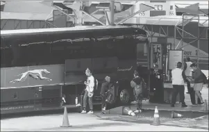  ?? CP PHOTO ?? Passengers place their luggage on a Greyhound bus before departing from Vancouver, on Monday.