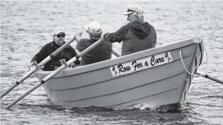  ?? Kathy Johnson ?? Leona Goreham (from left), Frank Hubbard and Steven Goreham row out from the North East Point waterfront towards the Cape Sable Island Causeway for the Row for Nanny’s Cure Silent Row, held to remember those who have lost their battle to cancer.