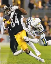  ?? Justin K. Aller Getty Images ?? SAFETY Derwin James tackles Pittsburgh receiver Antonio Brown in the first half of Chargers’ victory.