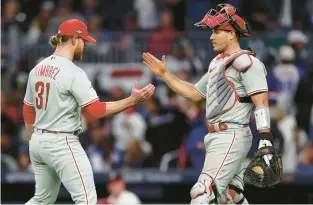  ?? ELSA/GETTY ?? The Phillies’ Craig Kimbrel, left, and J.T. Realmuto react after defeating the Atlanta Braves during Game One of the NL Division Series on Oct. 7 at Truist Park in Atlanta.