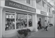  ?? DANA JENSEN/THE DAY ?? August Wolf, left, of Norwich and Bettyann Peck, of Seymour, leave Hang the Moon last week while shopping in downtown Mystic.