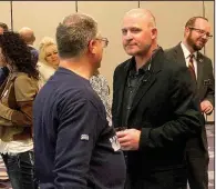  ?? (Arkansas Democrat-Gazette/Trenton Daeschner) ?? Arkansas Travelers Manager Dave Berg meets with a fan Monday night at the club’s annual Hot Stove Banquet in Little Rock. Berg will enter his first season leading the Seattle Mariners’ Class AA affiliate this year.