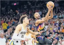  ?? MATT YORK/AP ?? Mikal Bridges drives past Jaxson Hayes during the Suns’ 112-97 victory over the Pelicans on Tuesday in Game 5 of their Western Conference first-round playoff series.