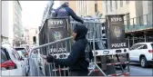  ?? Michael M. Santiago
/ Getty Images /TNS ?? NYPD drop off metal barricades in front of Manhattan Criminal Court on Monday in Newyork City.