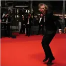  ?? Photograph: Patrícia de Melo Moreira/AFP/Getty Images ?? Let’s Dance … Brett Morgen dances as he arrives at the 75th edition of the Cannes film festival for the screening of Moonage Daydream.