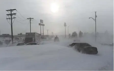  ?? RJ Sangosti, The Denver Post ?? A bulldozer clears snowdrifts Thursday in Limon that were left by Wednesday’s bomb cyclone, which swept across much of Colorado with hurricane-force winds. Hundreds of people were trapped on Colorado interstate­s and highways for hours.