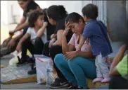  ?? MARCO UGARTE ?? Migrants wait at an immigratio­n center on the Internatio­nal Bridge 1, in Nuevo Laredo, Mexico, Tuesday, July 16, 2019. A U.S. policy to make asylum seekers wait in Mexico while their cases wind through clogged U.S. immigratio­n courts has also expanded to the violent city of Nuevo Laredo.