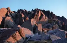  ??  ?? Rocks on Mount Townsend, in the glow of evening during a recent search.