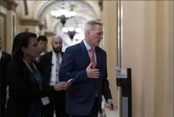 ?? J. Scott Applewhite/Associated Press ?? House Minority Leader Kevin McCarthy, R-Calif., who is hoping to become the next speaker of the House in the new Republican majority, leaves the chamber Friday after railing against the massive $1.7 trillion spending bill.