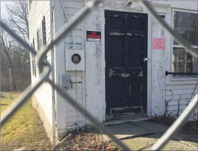  ?? Hearst Connecticu­t Media file photo ?? The town’s insurance provider has required no-trespassin­g and warning signs posted and a fence installed around the Bridgewate­r Grange. Costs are needed to determine if the historic building should be restored or replaced with a new building.