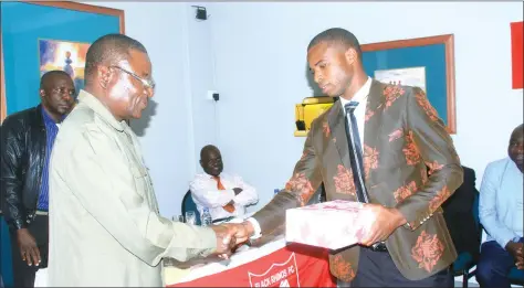  ??  ?? NUMERO UNO . . . Former Black Rhinos chairman and guest of honour Justin Mujaji (left) congratula­tes Bruce Homora after the defender was named the best player at the army side in Harare last night. — (Picture by Munyaradzi Chamalimba)