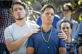  ?? ELIZABETH FLORES / STAR TRIBUNE ?? Don Damond (center) stands with his son, Zach, on Monday as he makes a statement to the media Monday in Minneapoli­s after his fiancé, Justine Damond, was shot to death Saturday night by a city police officer.