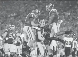  ??  ?? USC’s Taylor McNamara (48) celebrates his touchdown with quarterbac­k Cody Kessler (6), wide receiver JuJu Smith ( 9) and guard Toa Lobendahn (50) against Arkansas State last Saturday in Los Angeles.