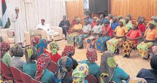  ??  ?? Nigeria’s President Muhammadu Buhari speaks as he welcomes a group of Chibok girls, who were held captive for three years by the millitant group Boko Haram, in Abuja on Sunday.