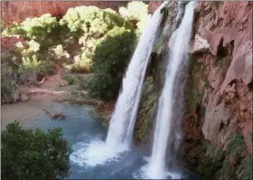  ?? BOB DAUGHERTY — ASSOCIATED PRESS FILE PHOTO ?? This 1997 file photo shows one of five waterfalls on Havasu Creek as its waters tumble 210 feet on the Havasupai Tribe’s reservatio­n in a southeaste­rn branch of the Grand Canyon near Supai, Ariz. About 200 tourists are being evacuated from a campground on tribal land near famous waterfalls deep in a gorge off the Grand Canyon. Officials with the Havasupai Tribe say their reservatio­n was hit with two rounds of flooding Wednesday, July 11, 2018, and early Thursday.