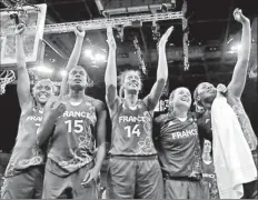  ??  ?? France's players celebrate victory against Russia after their women's basketball semifinal match at the North Greenwich Arena during the London 2012 Olympic Games August 9, 2012.