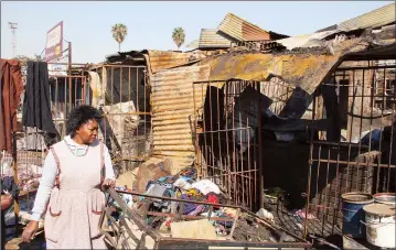  ??  ?? A trader counts her losses after property worth thousand of dollars went up in smoke at Magaba Market Stalls in Mbare, Harare, on Monday night. - (Picture by Innocent Makawa)