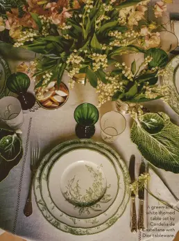  ?? ?? A green-andwhite themed table set by Cordelia de Castellane with Dior tableware.