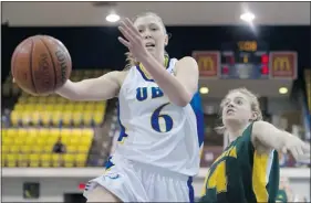  ?? RICHARD LAM — UBC ATHLETICS ?? Kris Young drives to the basket for the Thunderbir­ds past Alberta’s Katie Arbuthnot on Thursday night.