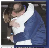  ??  ?? SAFELY BACK: Astronaut Nick Hague embraces his wife, Catie, in Kazakhstan after surviving the failure of a booster rocket yesterday.