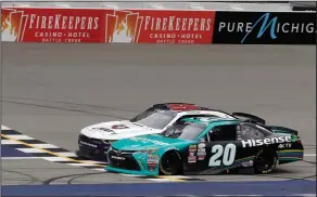  ?? Associated Press ?? RACE: Denny Hamlin (20) edges out William Byron at the checkered line, Saturday, June 17, 2017, to win the NASCAR Xfinity series auto race in Brooklyn, Mich.