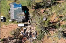  ?? HYOSUB SHIN / HSHIN@AJC.COM ?? Michael damagedstr­uctures off Flint River Estates Road in Roberta. Some 70,000 Georgians have filed residentia­l and agricultur­al insurance claims. FEMA has opened help centers across a 20-county region that was declared a disaster zone.