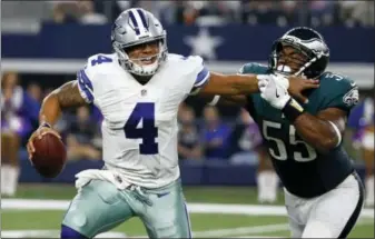  ?? MICHAEL AINSWORTH — THE ASSOCIATED PRESS ?? Dallas Cowboys quarterbac­k Dak Prescott (4) fights off pressure from Philadelph­ia Eagles defensive end Brandon Graham (55) during a game last season.