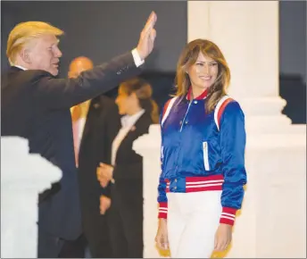  ?? AP PHOTO ?? President Donald Trump and first lady Melania turn to go inside after viewing the Florida Atlantic University Marching Band at Trump Internatio­nal Golf Club in West Palm Beach, Fla.