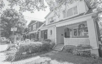  ??  ?? This two-storey, renovated, semi-detached home has a front porch and interlocki­ng brick walkway.