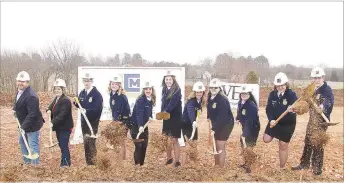  ?? LYNN KUTTER ENTERPRISE-LEADER ?? Members of Lincoln High FFA Chapter and their sponsors, Kevin Barenberg (left) and Sarah Hale, help with a groundbrea­king ceremony for a new animal science lab on Monday, Feb. 24. The building should be ready by mid- June and will provide a place for hands-on learning for agricultur­e students.