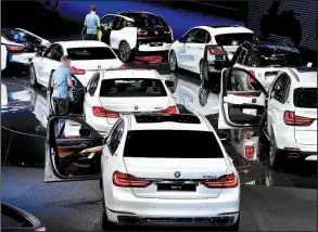  ?? AP/MICHAEL PROBST ?? Drivers settle into BMW vehicles on display Wednesday at an auto show in Frankfurt, Germany.