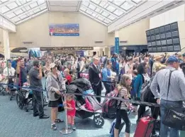  ?? KAYLA O’BRIEN/STAFF ?? Passengers at Orlando Internatio­nal Airport wait in long lines Wednesday to get through security; 14,000 travelers were affected when one of OIA’s new shuttles broke down.