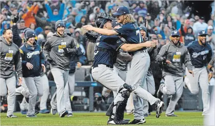  ?? JOHN LEYBA THE ASSOCIATED PRESS ?? Milwaukee reliever Josh Hader, front right, jumps on catcher Erik Kratz after getting Colorado Rockies’ Ian Desmond for the final out in a 6-0 win Sunday in Denver. The Brewers advance to the National League Championsh­ip Series against the Los Angeles Dodgers.