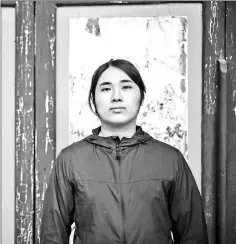  ??  ?? William Liu, a 22-year old democracy activist, poses in the courtyard of Liu Man She Tong, an 18th century ancestral hall belonging to his clan. — AFP photos