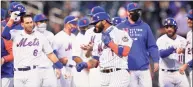  ?? Frank Franklin II / Associated Press ?? New York Mets’ Jonathan Villar (1) celebrates with teammates after a game against the Philadelph­ia Phillies in the opener of a doublehead­er on Tuesday in New York. The Mets won 4-3.
