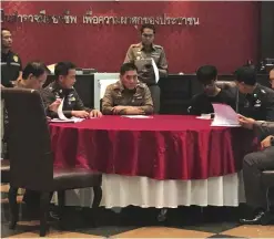  ??  ?? BANGKOK: Natdanai Kongdee (third from right) is interviewe­d at the police headquarte­rs in Bangkok yesterday. Police in Thailand have charged 19-year-old Kongdee in connection with a series of recent hacking attacks on government computers that were...